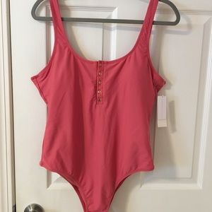 Raisins, Pink/red one piece swimsuit.